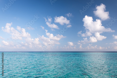 Tropical turquoise lagoon in  Indian Ocean. Bright blue sky with clouds. Used a polarizing filter © patma145