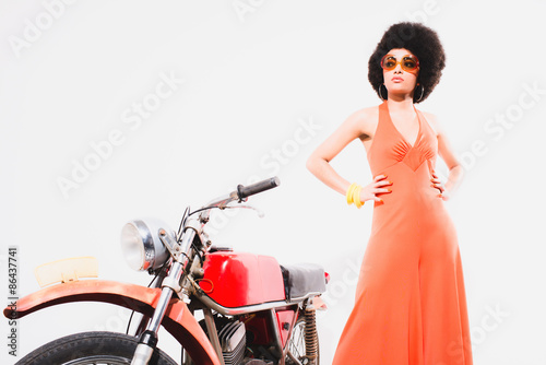 Fotografija Elegant Young Woman Standing Beside Motorcycle