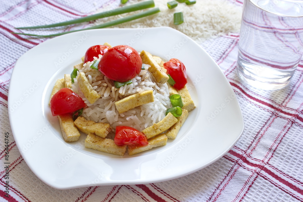 basmati rice with pieces of roasted tofu, tomatoes and onion