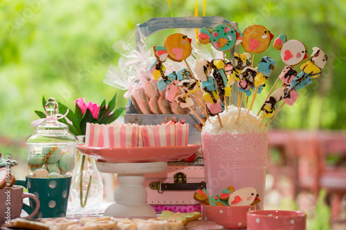 Prepared birthday table with sweets for children party photo