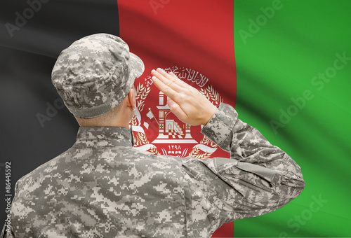 Soldier in hat facing national flag series - Afghanistan photo