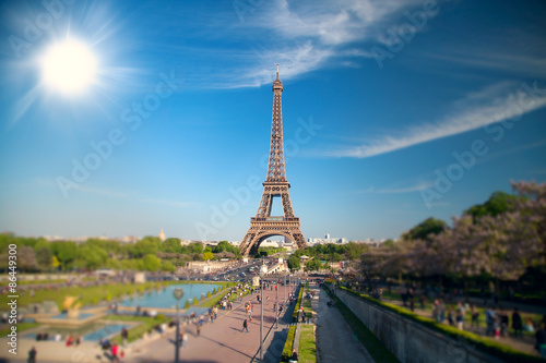 summer day the sun shines over the Eiffel Tower symbol of Paris. © Aliaksei