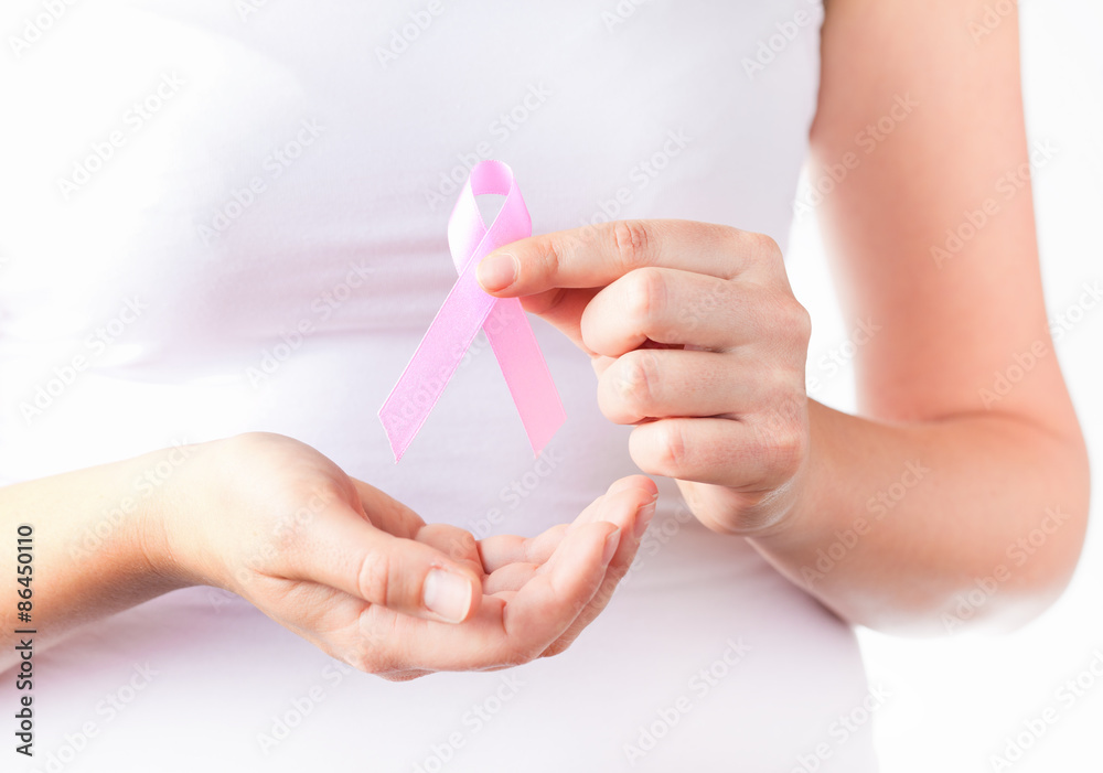 woman`s hands holding pink breast cancer awareness ribbon
woman`s hands holding pink breast cancer awareness ribbon
