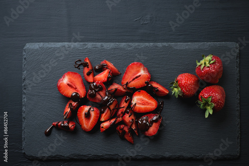 Εκτύπωση καμβά Ripe strawberries with chocolate on a stone slate dish
