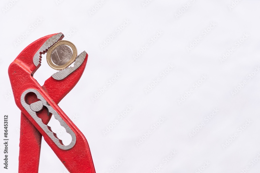 Naklejka premium Euro coin squezzed with pliers. 