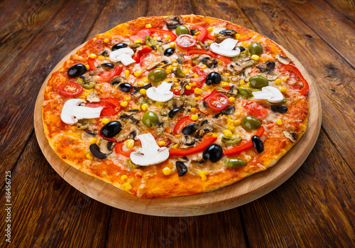 Delicious vegetarian pizza with tomatoes, mushrooms and olives