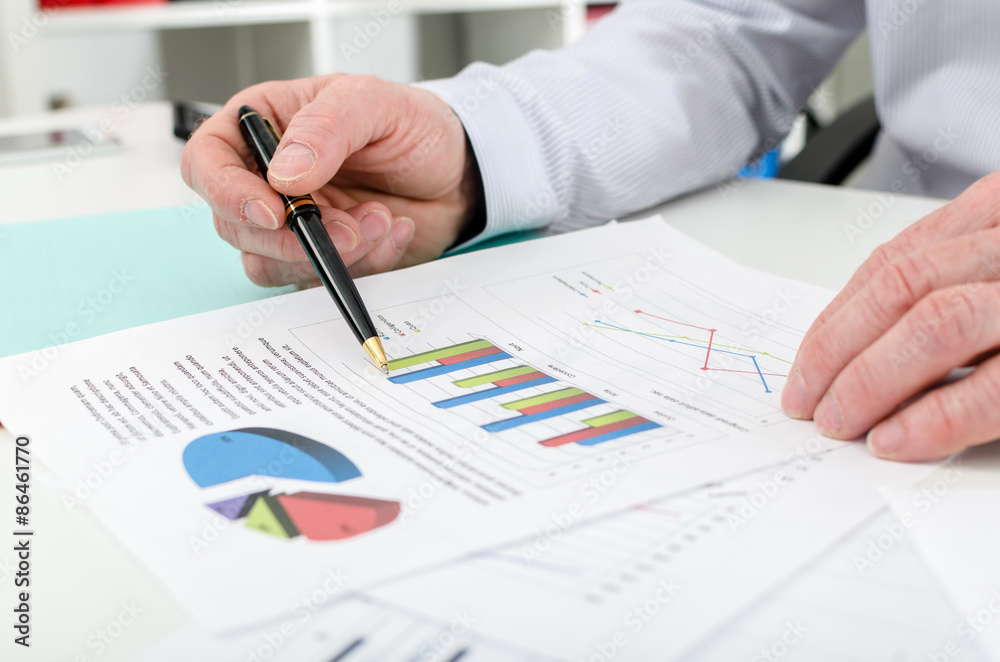 Businessman checking financial graphs