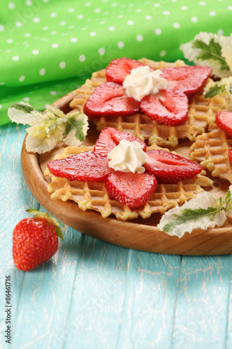Strawberry dessert with cream on a wooden platter