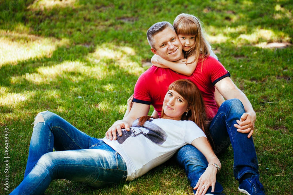 A young family, a pregnant mother, father, daughter