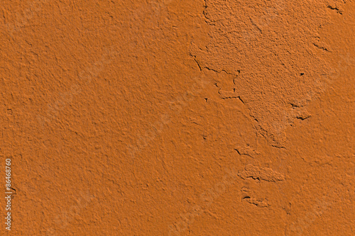An orange concrete wall with finegrained textures mostly some parts are more rough  photo