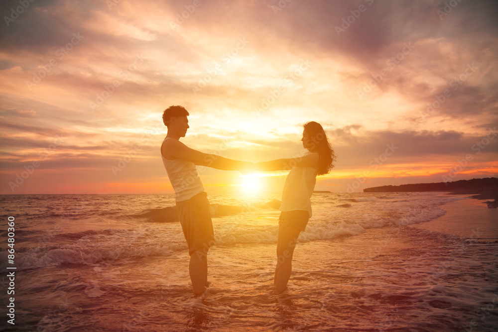 young couple  at sunset on beach