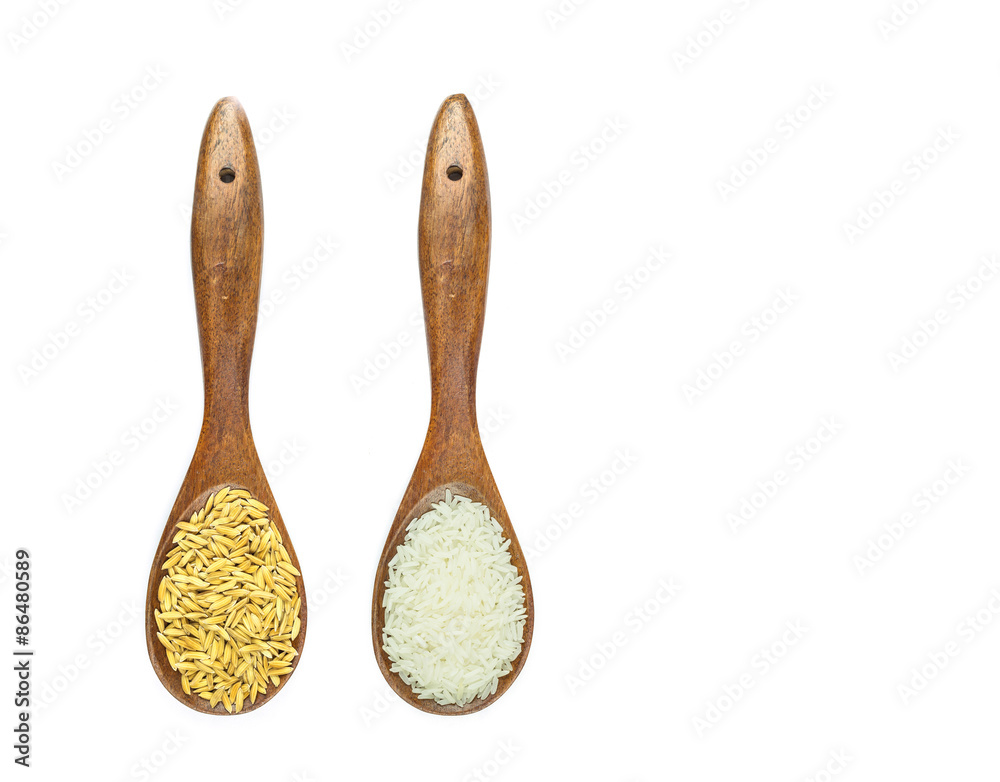 Thai jasmine rice in wooden spoon isolated on white Thai jasmine rice in wooden spoon isolated on white