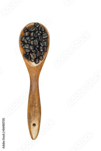 Coffee beans in wooden spoon isolated on white