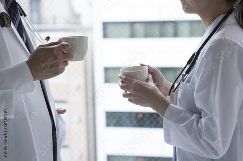 Doctors who are drinking coffee at the window photo