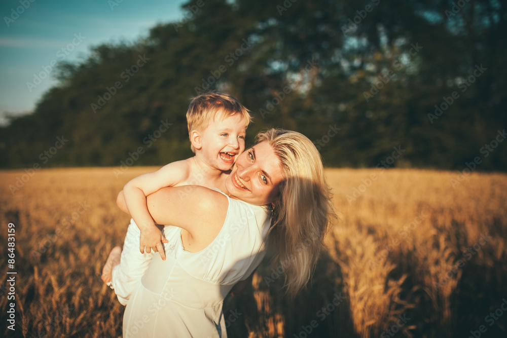Happy family. Portrait of happy loving mother and her baby outdoors Happy family. Portrait of happy loving mother and her baby outdoors