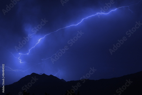 Bolt of lightning over the mountains during a summer thunderstorm