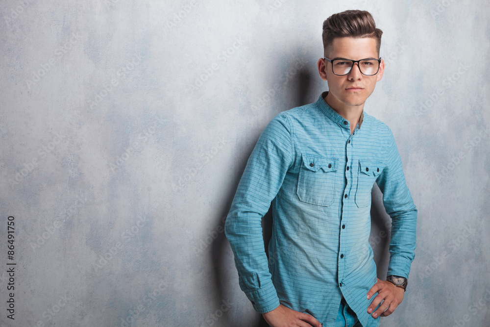 Young man wearing a blue shirt and glasses