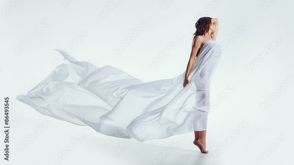 Sensual brunette posing with a flying transparent cloth Sensual brunette posing with a flying transparent cloth