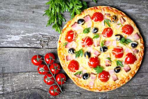 pizza with bacon  olives and tomato