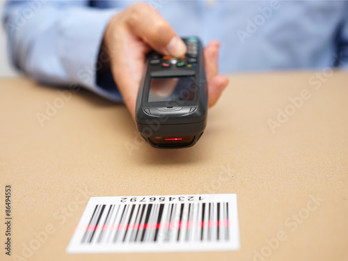 warehouse technician inspects stocks in storage with bar code re