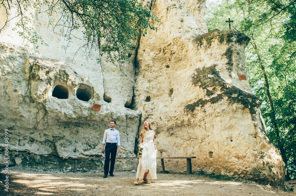 wedding couple near rock