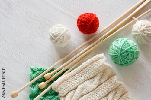 Two bright patterns, yarn balls and needles for knitting wooden
