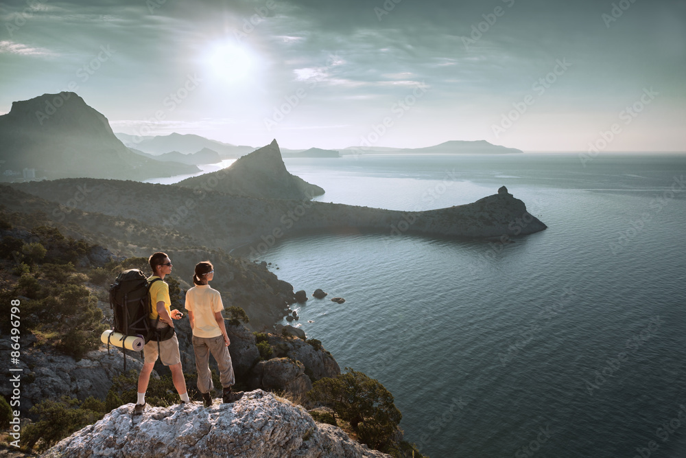 Fototapeta premium Hikers look at sunrise