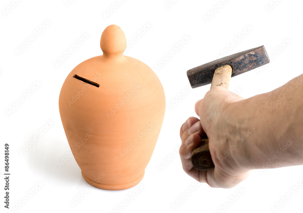 Rompere un salvadanaio con un martello - Break a money box or a piggy bank  with a hammer Stock Photo