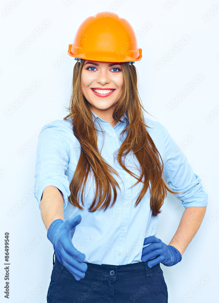 Smiling business woman wearing a building helmet and glow givin Smiling business woman wearing a building helmet and glow givin