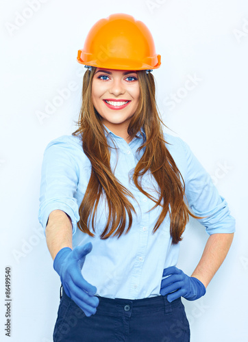Smiling business woman wearing a building helmet and glow givin