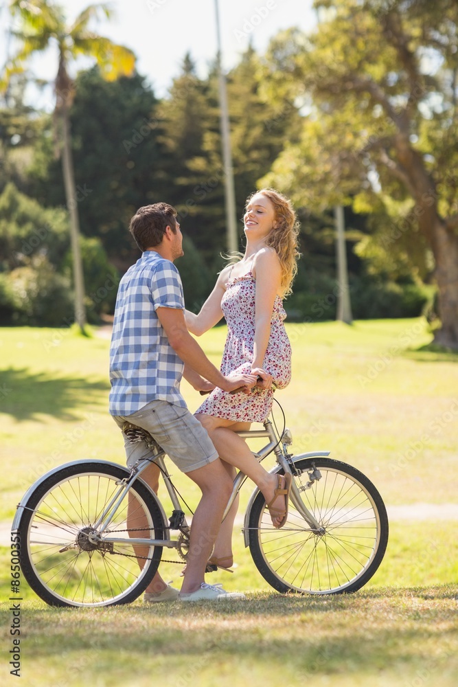 Young couple on a bike ride in the park Young couple on a bike ride in the park