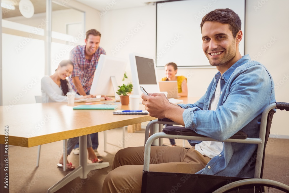 Creative businessman in wheelchair holding a phone Creative businessman in wheelchair holding a phone
