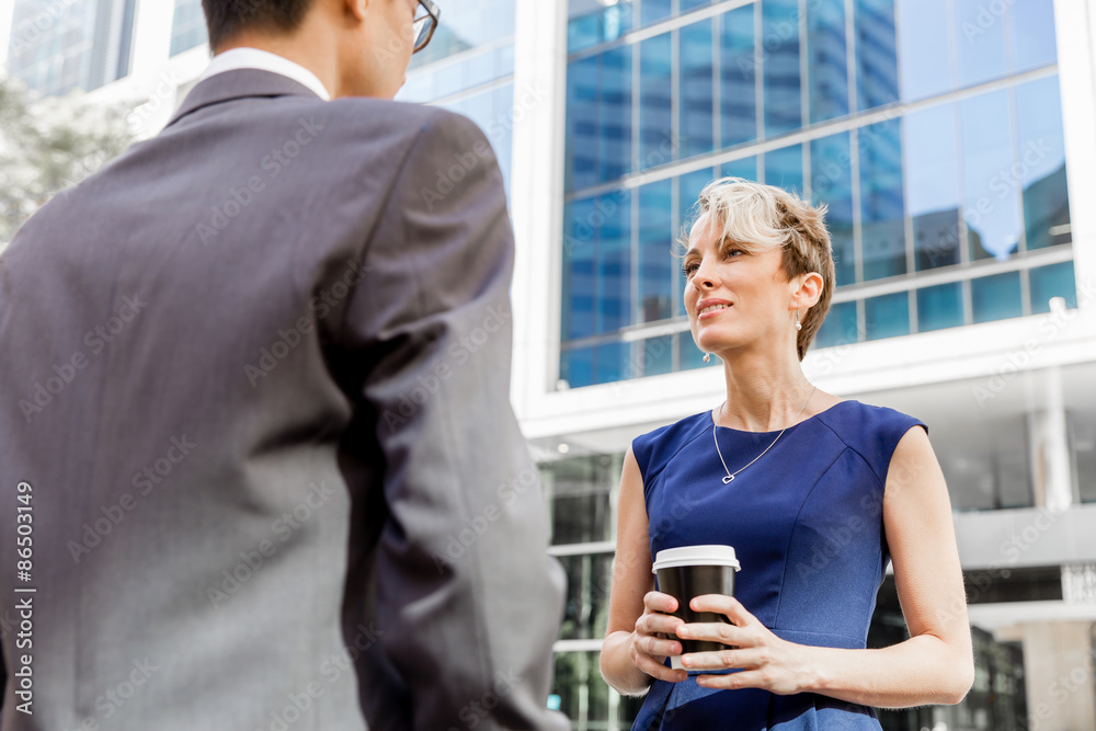 Fototapeta premium Two colleagues walking together in a city
