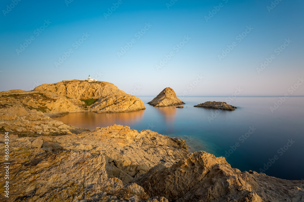 Red rocks and lighthouse of Ile Rousse in Corsica
