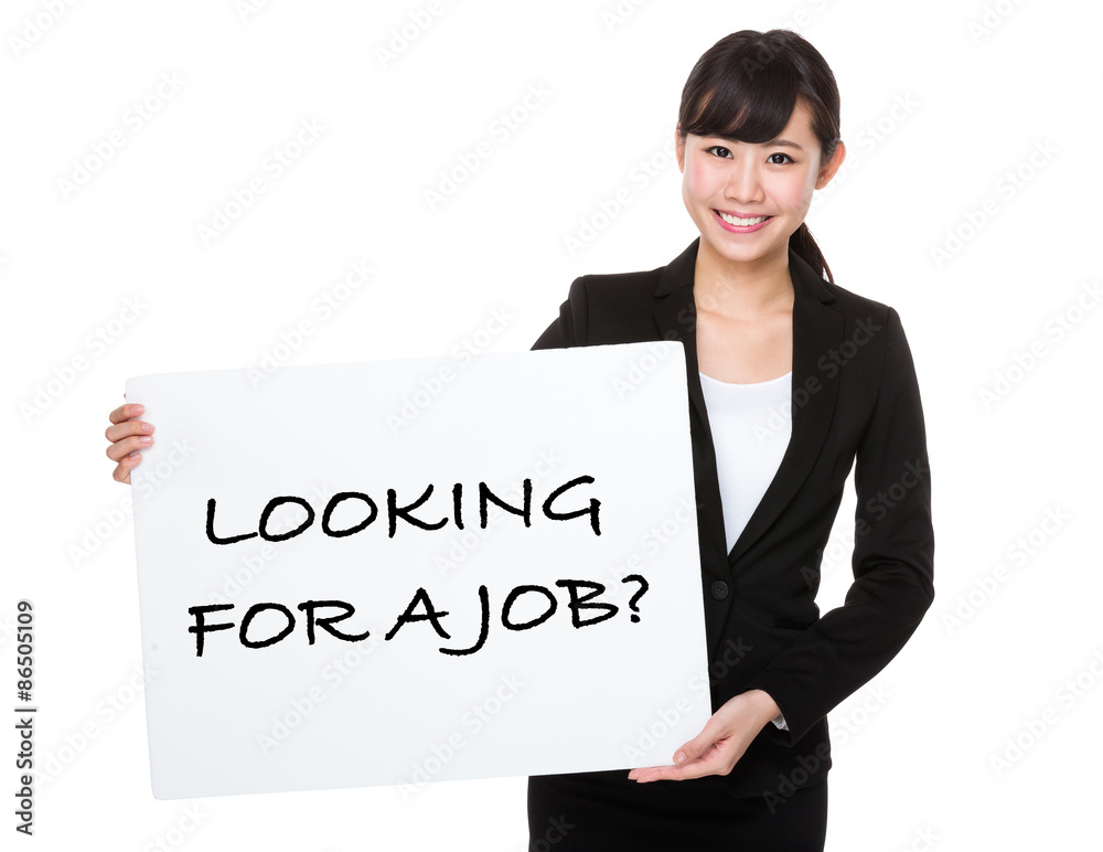 Beautiful businesswoman showing a poster showing with looking fo Beautiful businesswoman showing a poster showing with looking fo