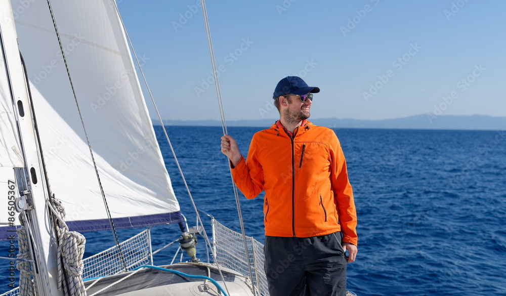 Man sailing with sails out on a sunny day Man sailing with sails out on a sunny day