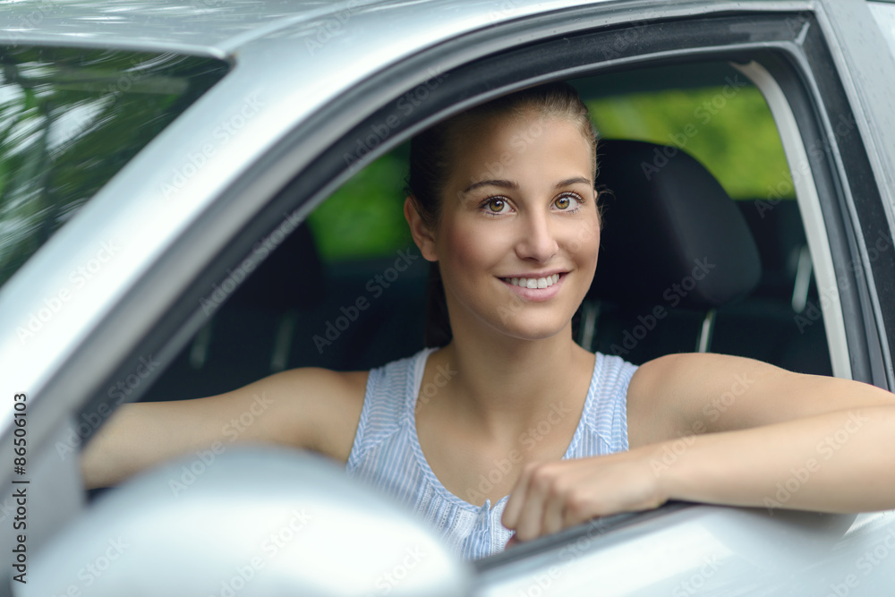 Smiling attractive woman driving a car