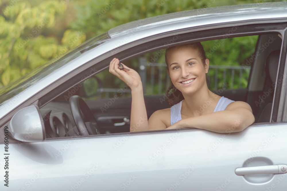 Smiling Young Woman in her Car Holding Keys