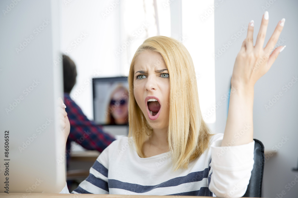 Shocked young woman working on computer Shocked young woman working on computer