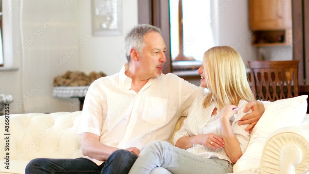 Couple talking and wathing a tv program Couple talking and wathing a tv program
