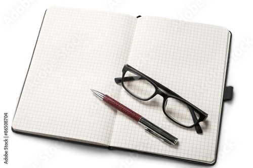 Glasses, pen, desk.