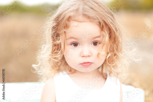 Cute baby girl with blonde curly hair outdoors. Little girl 2-3 year old. Stock Photo | Adobe Stock Cute baby girl with blonde curly hair outdoors. Little girl 2-3 year old. Stock Photo | Adobe Stock