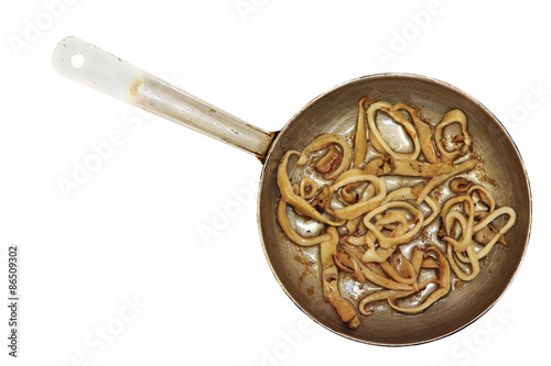 Roasted squids pieces  in frying pan.Isolated.