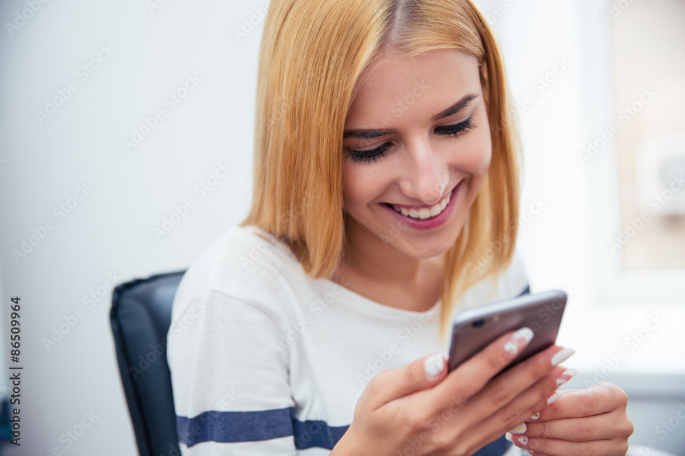 Woman using smartphone in office Woman using smartphone in office
