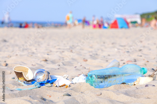 Garbage on a beach left by tourist at sunset, Baltic Sea, Poland.