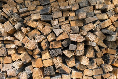 Many dry chopped firewood logs. Horizontal.