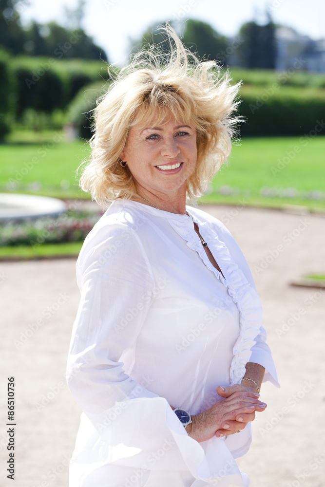 Portrait of lovely middle aged woman in the summer park Portrait of lovely middle aged woman in the summer park