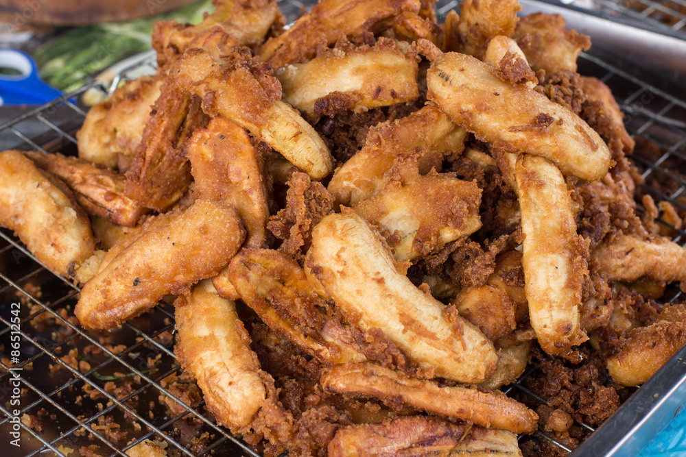 Fried bananas are one of Thai snacks. Bananas to be cut or sliced in half, and dip into dough. Then cook them with hot oil in a frying pan. Fried bananas are one of Thai snacks. Bananas to be cut or sliced in half, and dip into dough. Then cook them with hot oil in a frying pan.
