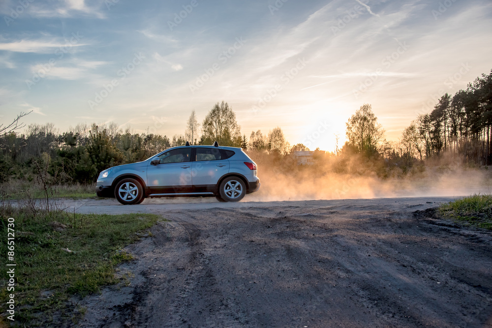 Cloud of dust behid a car driving through a dry unmade road Cloud of dust behid a car driving through a dry unmade road