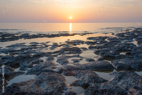 Sandstone rocks at the sea on beautiful sunrise
